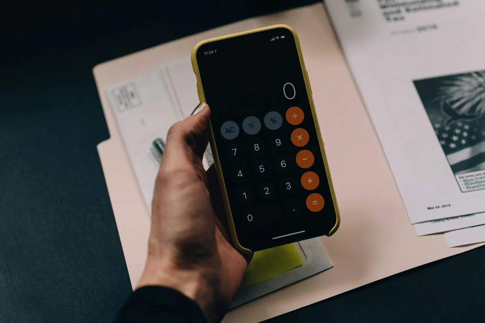 Financial documents, calculator, and laptop showing the difference between accounting profit and real cash flow