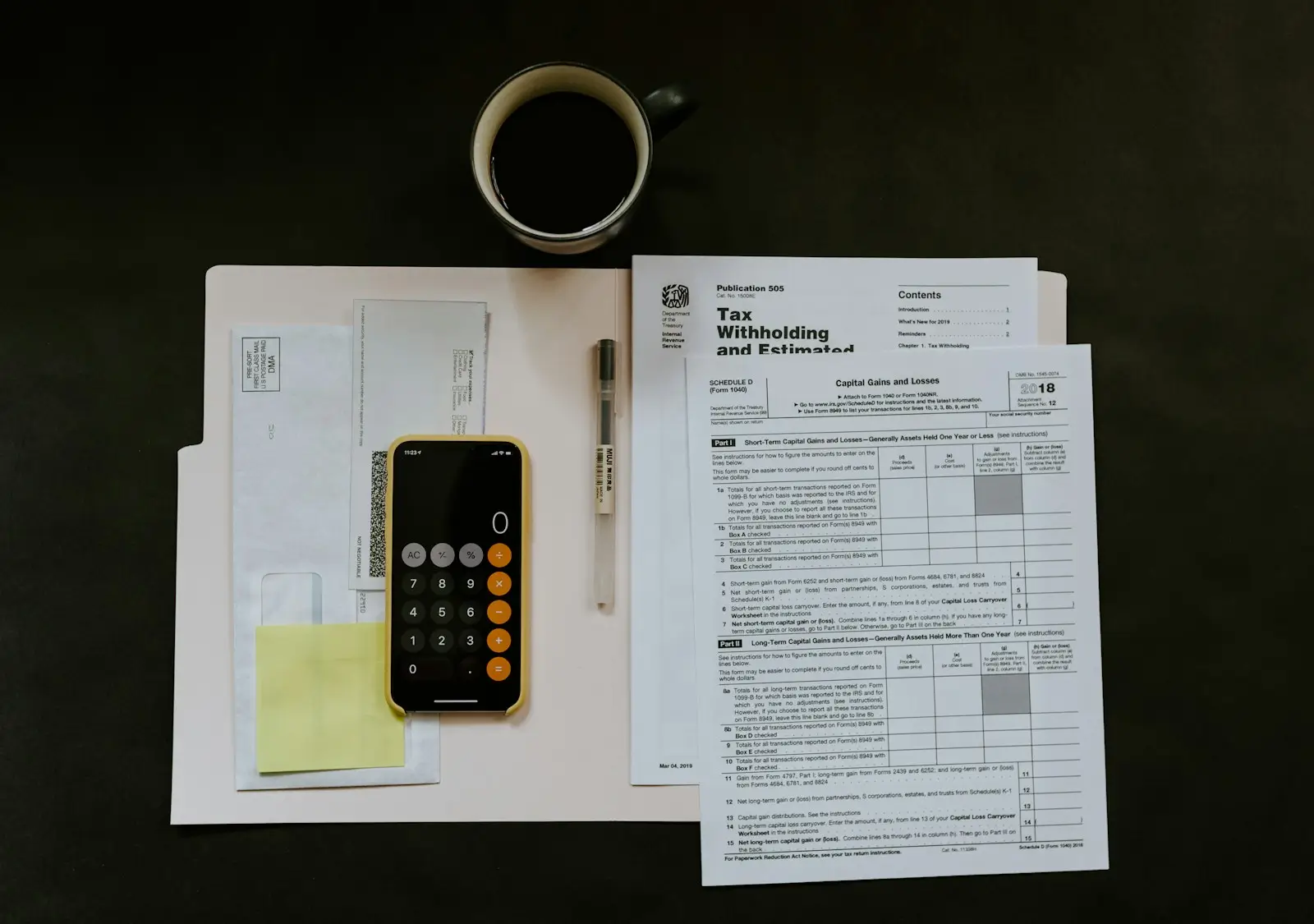 Small business owner using a smartphone app to scan receipts into cloud bookkeeping software on a desk